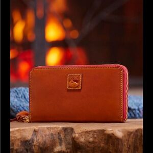 Women’s Dooney & Burke large zip around wristlet wallet.